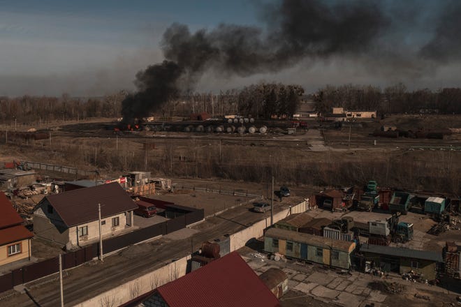 Smoke billows from burning containers after shelling in Vasylkiv, south west of Kyiv, Ukraine, Saturday, March 12, 2022. 