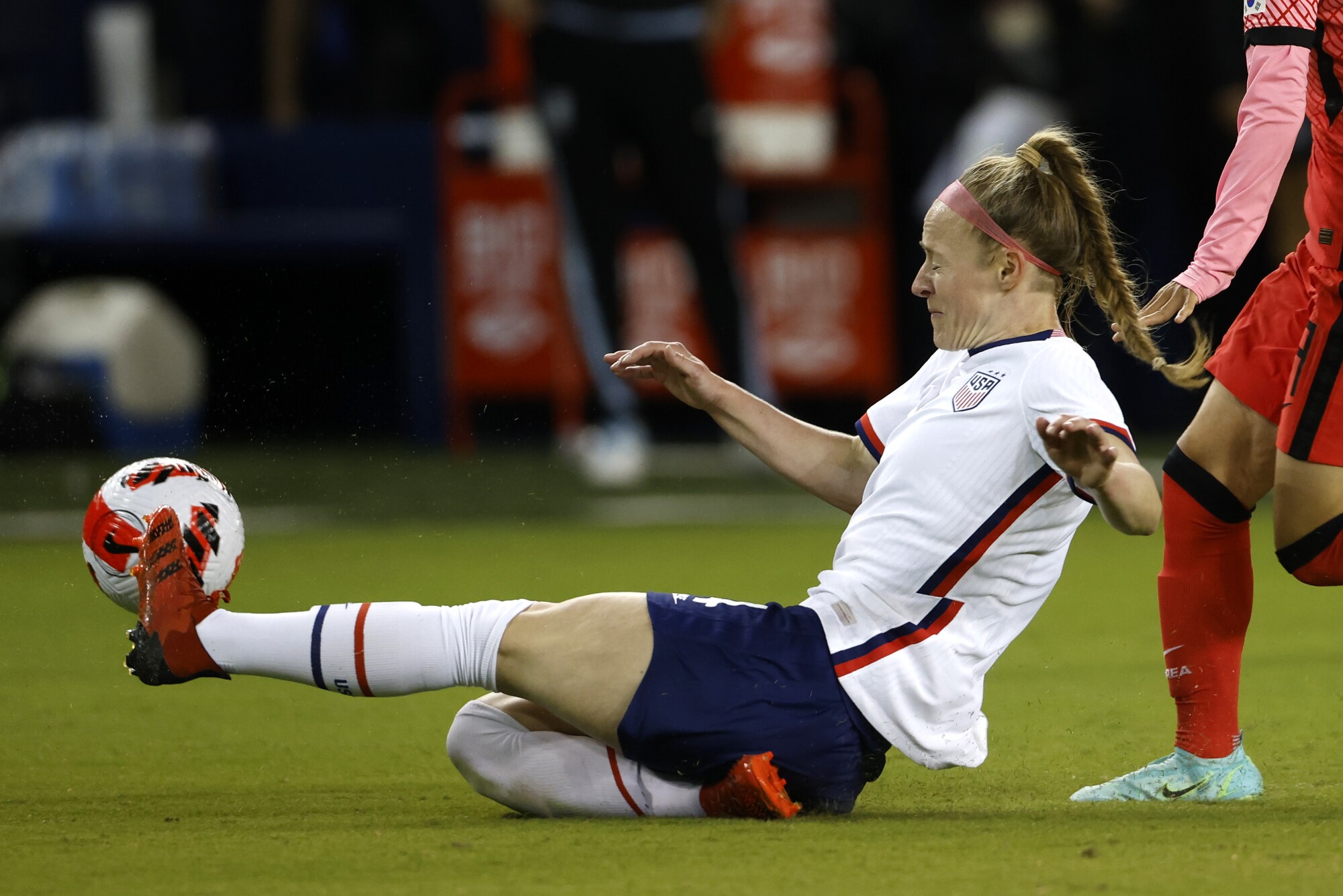 U.S. defender Becky Sauerbrunn slides during a 2021 international friendly soccer match against South Korea 