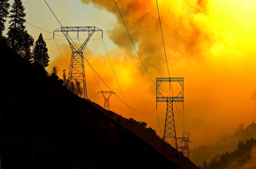 Power transmission lines crest a hilltop above Camp Creek Road, the point of origin of the Camp fire, in 2018.