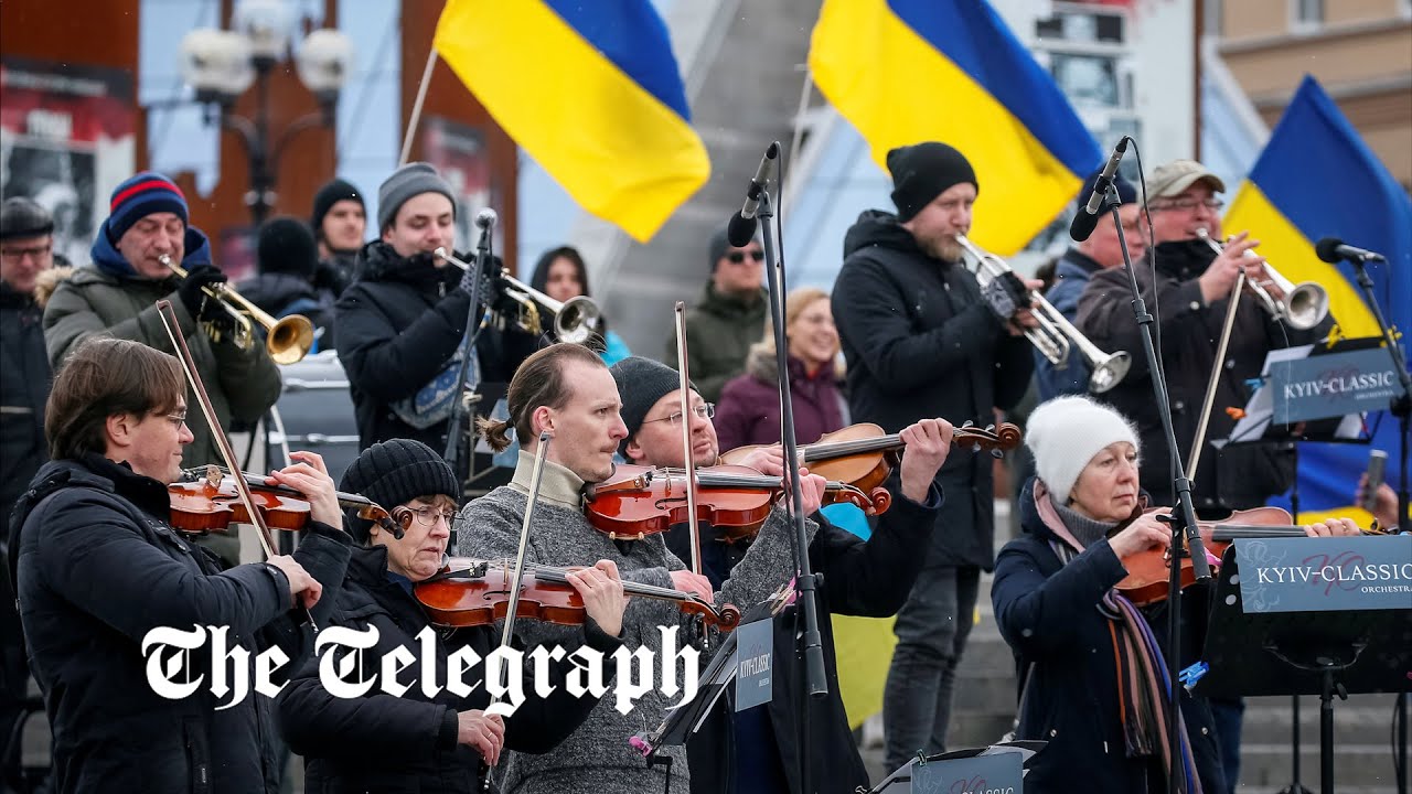 'Stop the war in Ukraine': Orchestra plays national anthem in central Kyiv as Russians advance