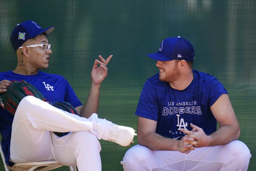 Dodgers pitchers Julio Urías and Caleb Ferguson talk during a spring training workout.
