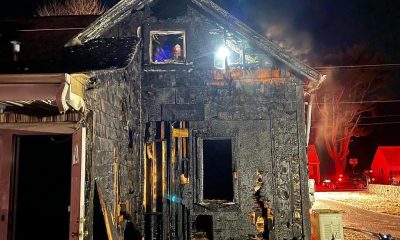 Massachusetts fire fighters enter burning building to rescue trapped dog