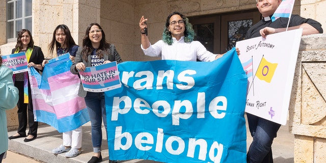 Adri Perez, ACLU of Texas Policy and Advocacy Strategist, center, and other LGBTQ leaders speak outside the Travis County courthouse where a hearing was held to stop the new child welfare investigations targeting supportive families of transgender children, on Wednesday, Mar. 02, 2022, in Austin.