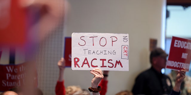 Opponents of Critical Race Theory attend a packed Loudoun County School board meeting until the meeting erupted into chaos and two people were detained, in Ashburn, Virginia, June 22, 2021.