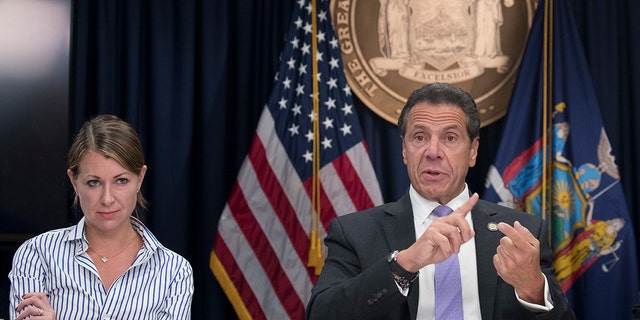 FILE - Secretary to the Governor Melissa DeRosa, left, joins New York Gov. Andrew Cuomo as he speaks to reporters during a news conference on Sept. 14, 2018, in New York. (AP Photo/Mary Altaffer)