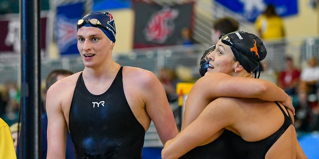 Texas swimmers Erica Sullivan and Evie Pfeifer embrace as 500 Freestyle winner Lia Thomas walks past during the NCAA Swimming and Diving Championships on March 17th, 2022 at the McAuley Aquatic Center in Atlanta Georgia.  