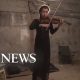 Ukrainian woman plays violin from apartment basement in Kharkiv