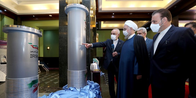 President Hassan Rouhani, second right, listens to head of the Atomic Energy Organization of Iran Ali Akbar Salehi while visiting an exhibition of Iran's new nuclear achievements in Tehran, Iran, in April 