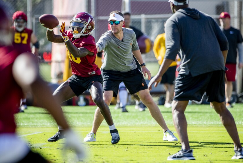 USC coach Lincoln Riley interacts with wide receiver Kyron Ware-Hudson.