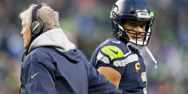 Head coach Pete Carroll and Russell Wilson of the Seattle Seahawks at Lumen Field on Jan. 2, 2022 in Seattle, Washington.