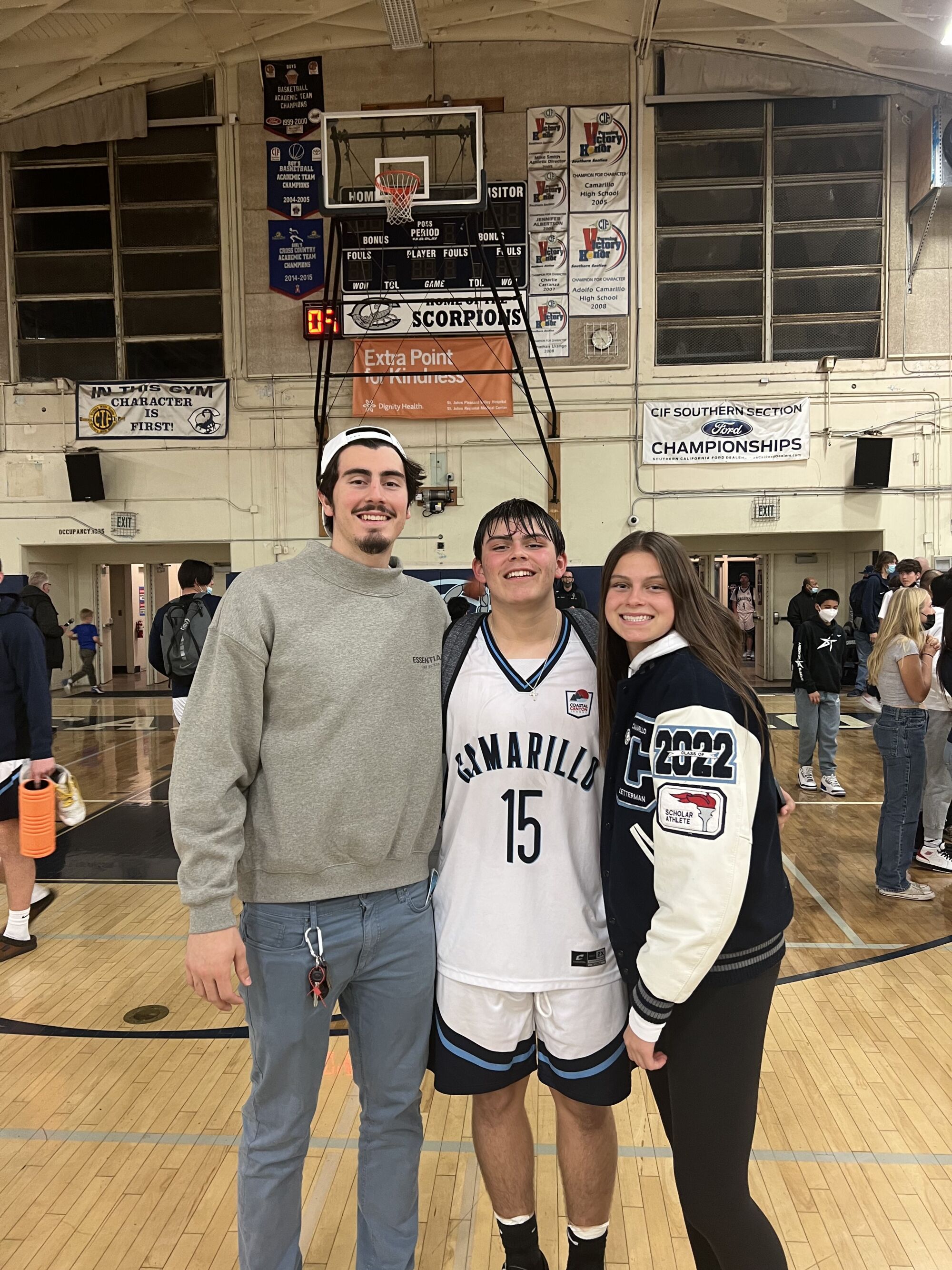 Jaime, left, Marcos and Gabriela Jaquez gather for a photo after one of Marcos' high school basketball games.