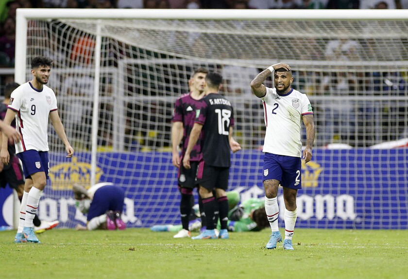 U.S. defender DeAndre Yedlin reacts after U.S. forward Christian Pulisic and Mexico goalkeeper Guillermo Ochoa collide.