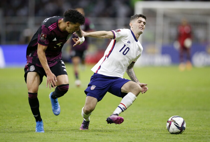 Mexico defender Jorge Sanchez, left, tries to steal the ball away from U.S. forward Christian Pulisic in the second half.