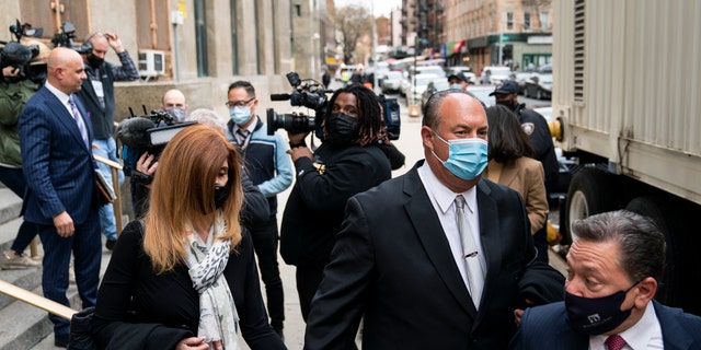 The parents of Lauren Pazienza leave criminal court trailed by members of the media after their daughter's arraignment Tuesday, March 22, 2022. (AP Photo/John Minchillo)