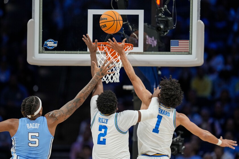 UCLA forward Cody Riley and guard Jules Bernard try to rebound a shot by North Carolina forward Armando Bacot.