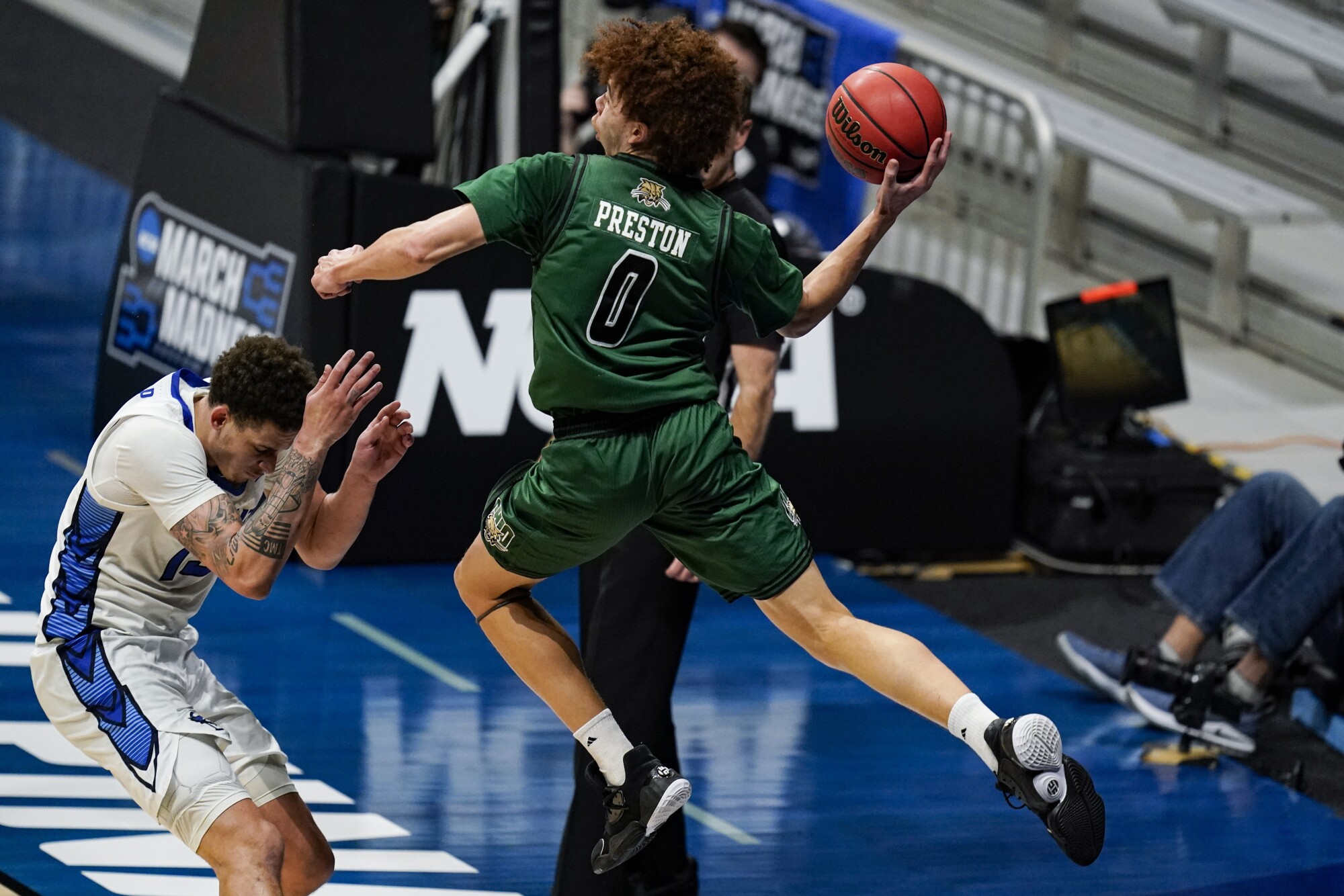 Jason Preston looks to make a pass after leaping to save the basketball from going out of bounds.