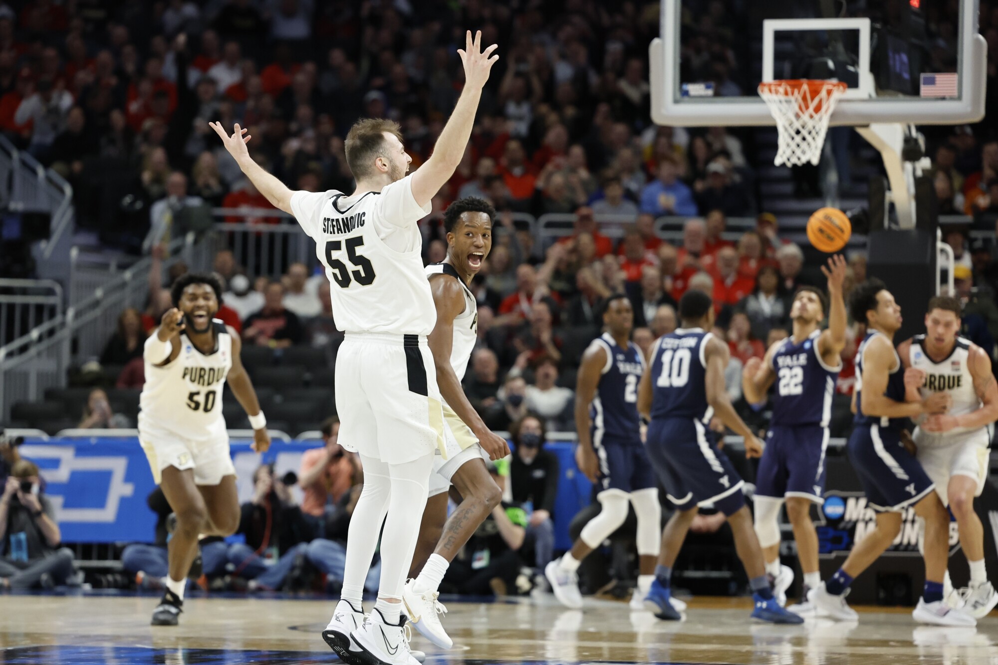 Purdue's Sasha Stefanovic raises his arms after making a three-pointer against Yale.