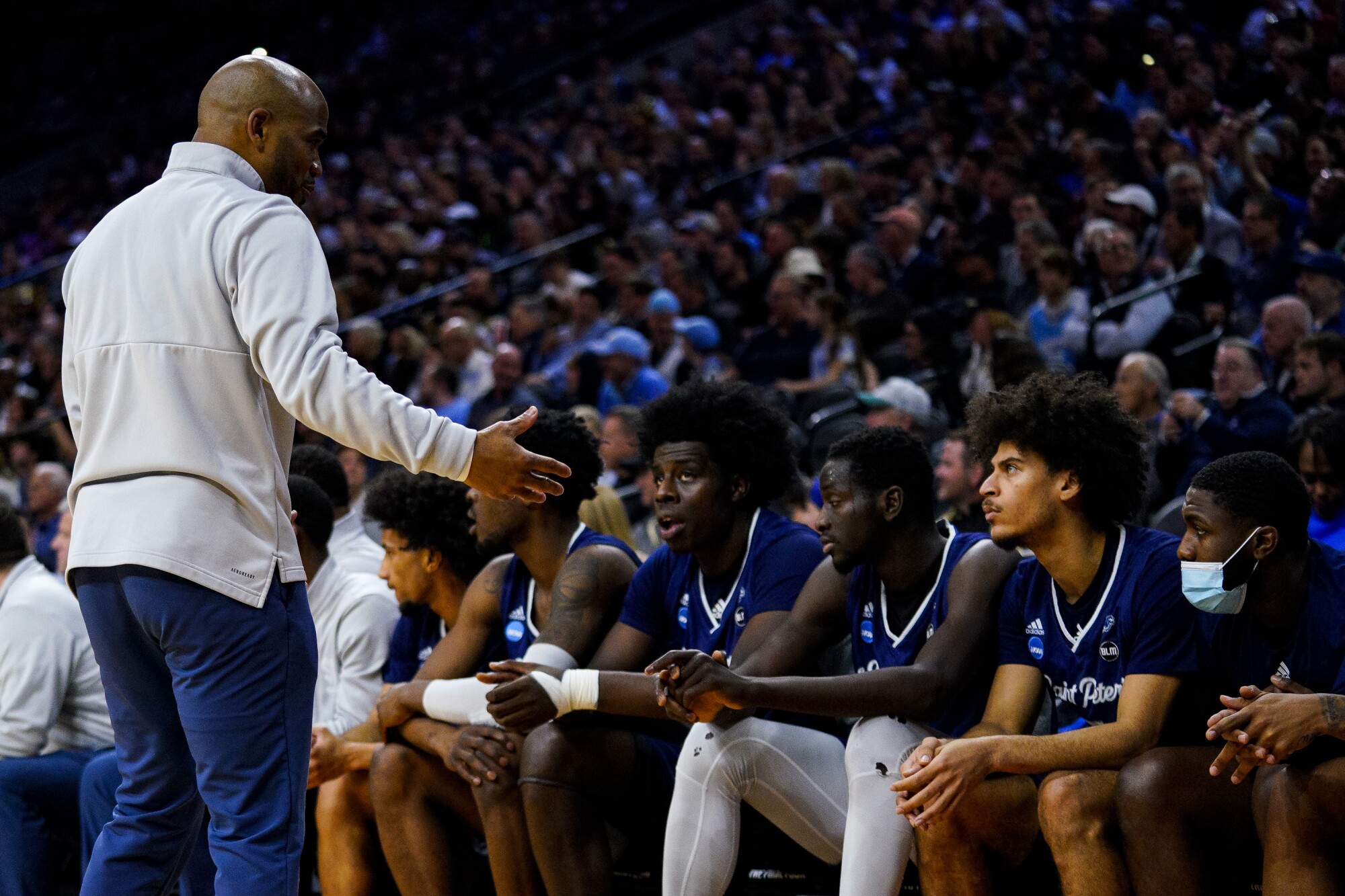 Saint Peter's coach Shaheen Holloway speaks to his players.