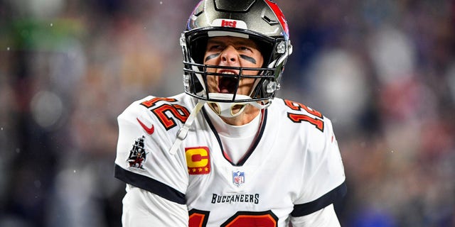 Tampa Bay Buccaneers quarterback Tom Brady yells to the crowd as he takes the field to face the New England Patriots at Gillette Stadium Oct. 3, 2021.