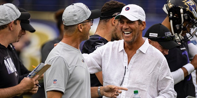 Head coach John Harbaugh of the Baltimore Ravens laughs with owner Steve Bisciotti during training camp at M&amp;amp;T Bank Stadium on July 31, 2021 in Baltimore, Maryland.