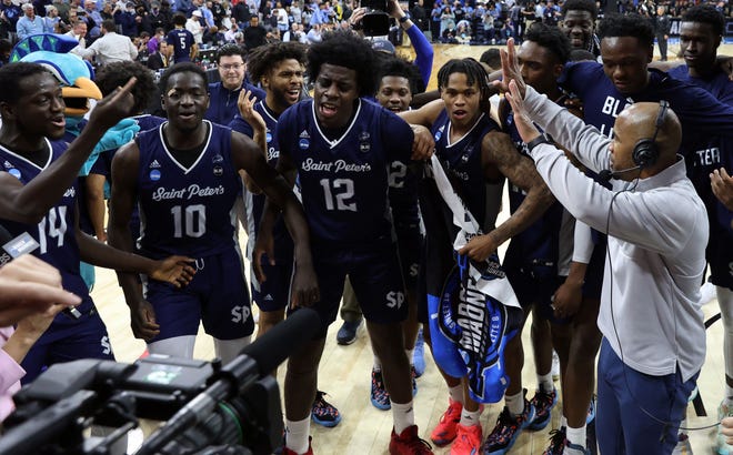 Saint Peter's celebrates its upset victory over Purdue.