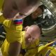 Russia’s astronauts enter the space station in yellow and blue flight suits.