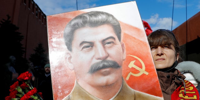 A supporter of the Russian Communist Party attends a ceremony in Red Square in central Moscow March 5, 2021, marking the 68th anniversary of Soviet leader Josef Stalin's death 