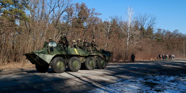 Members of the Ukrainian forces sit on a military vehicle amid Russia's invasion of Ukraine, in the Vyshgorod region near Kyiv, Ukraine March 10, 2022.  