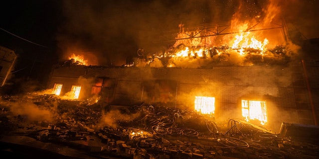 Rescuers work at a site of buildings damaged by a shelling, as Russia's attack on Ukraine continues, in Kyiv, Ukraine, in this handout picture released March 17, 2022.  