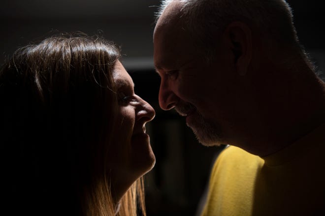 Tracy and Chris Etheridge hold each other in their living room in Waverly, Tenn., Thursday, March 10, 2022. The two recently married after Chris Etheridge saved Tracy from drowning in floodwaters in the flood that hit Waverly six months ago.”In the middle of the flood, we thought we were going to die,” Tracy Etheridge said, “And I remember he kissed me on the forehead.” 