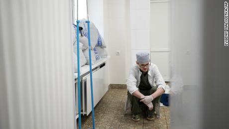 A medical worker at a hospital in Mariupol, Ukraine, after an 18-month-old died by shelling, on March 4, 2022.