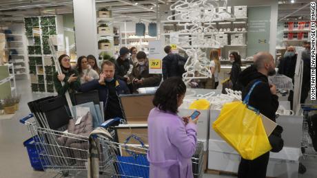 Shoppers wait in a line to pay for their purchases at the IKEA store March 3, 2022 in Moscow.