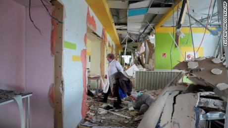 A medical worker walks through the hall of a maternity hospital damaged in a shelling attack on March 9 in Mariupol, Ukraine.
