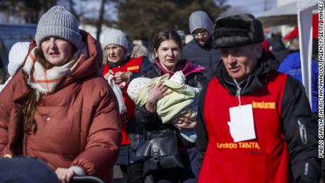 Refugees from Ukraine arrive March 9 at the Siret border post in Romania.