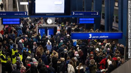 Crowds wait for a train to Berlin at Warsaw&#39;s central train station.