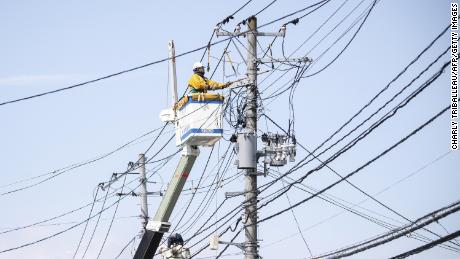 A worker conducts electrical work following a power outage in Soma, Fukushima Prefecture, Japan, on March 17.