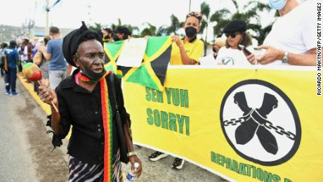 People call for slavery reparations outside the entrance of the British High Commission in Kingston, Jamaica on Tuesday.