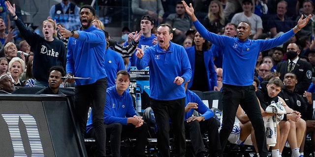 Duke head coach Mike Krzyzewski, middle, and assistant coaches react during the first half of a college basketball game between Duke and Texas Tech in the Sweet 16 round of the NCAA tournament in San Francisco, Thursday, March 24, 2022.