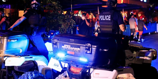 Miami Beach police officers enforce an 8 p.m. curfew imposed by local authorities on spring break festivities, amid the coronavirus disease (COVID-19) pandemic, in Miami Beach, Florida, U.S., March 26, 2021. REUTERS/Marco Bello