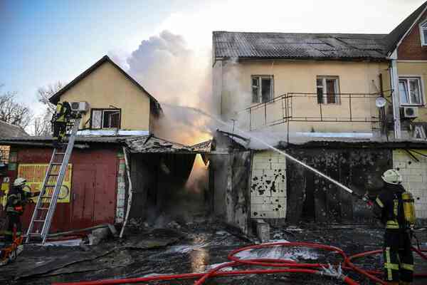 Damaged and burning yellow houses.