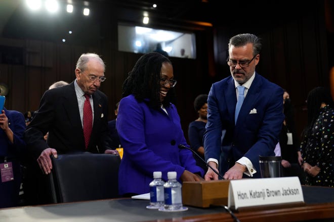 Dr. Patrick Jackson (r), helps his wife, Supreme Court nominee Ketanji Brown Jackson, as she arrives to appear before the Senate Judiciary Committee during her confirmation hearing on March 21, 2022 in Washington.