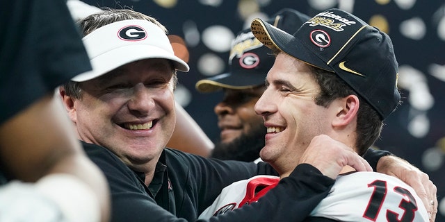 Georgia head coach Kirby Smart celebrates with Stetson Bennett after the College Football Playoff championship football game against Alabama Tuesday, Jan. 11, 2022, in Indianapolis. Georgia won 33-18.