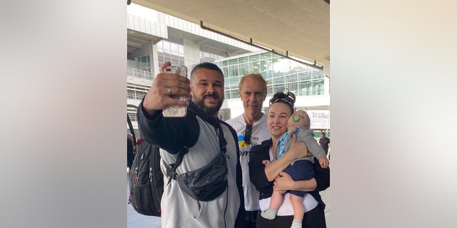 Irena Laura Yoder of Iowa is shown in Ukraine (at right) with her son TJ, grandson Mark (in her arms) and boyfriend Steven in September 2021.