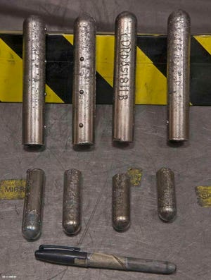 Eight rods of plutonium are displayed in this 2011 photo from the U.S. Department of Energy.