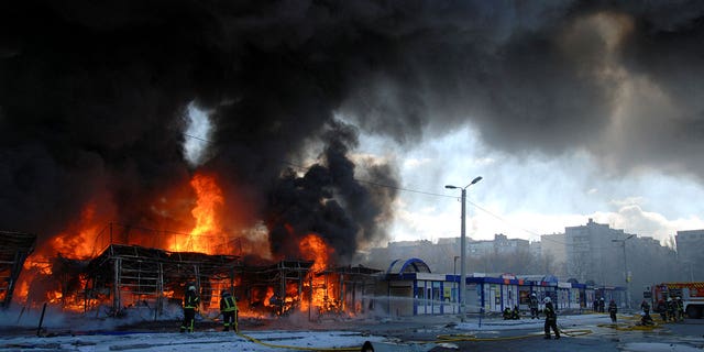 Firefighters work at a site of a fire, as Russia's invasion of Ukraine continues, in Kharkiv, Ukraine March 16, 2022. REUTERS/Oleksandr Lapshyn