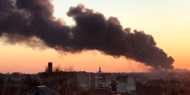 A cloud of smoke rises after an explosion in Lviv, western Ukraine, Friday, March 18, 2022. The mayor of Lviv says missiles struck near the city's airport early Friday. 