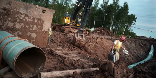 Workers make sure each section of the Enbridge replacement Line 3 that is joined passes muster in Superior, Wisconsin, Aug. 21, 2017.