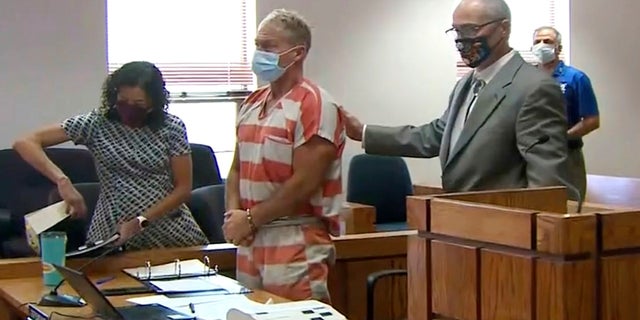 In this still image from video, Barry Morphew, center, appears in court in Salida, Colorado, on May 6. 