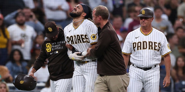 Padres' Fernando Tatis Jr. is helped off the field during the Colorado Rockies game on July 30, 2021, in San Diego. (AP Photo/Derrick Tuskan)