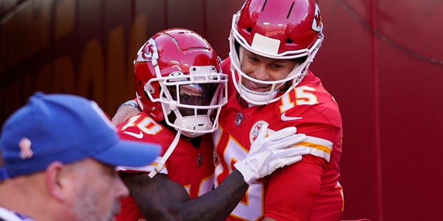 Kansas City Chiefs wide receiver Tyreek Hill (10) celebrates with quarterback Patrick Mahomes (15) after catching a 10-yard touchdown pass in the AFC championship game against the Cincinnati Bengals Jan. 30, 2022, in Kansas City, Mo.